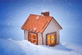 A small wooden house with brightly glowing windows on a winter evening in the snow, the concept of comfort and warmth in a wooden Royalty Free Stock Photo