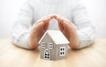 Small wooden house covered by hands