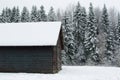 Small wooden house covered with snow