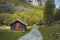 small wooden house with an earthen roof with grass and moss in the forest Royalty Free Stock Photo