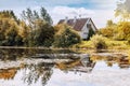 A small wooden house on the edge of a forest and on the shore of Royalty Free Stock Photo