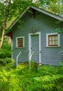 Small wooden house or hut in a forest Canada. Old cabin with in the woods. Wooden small cottage for camping among trees Royalty Free Stock Photo