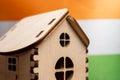 Small wooden house, India flag on background. Real estate concept, soft focus Royalty Free Stock Photo