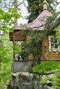 Small wooden house on a large stone in the forest Royalty Free Stock Photo