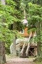 Small wooden house on a large stone in the forest Royalty Free Stock Photo