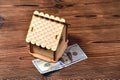 A small wooden house-piggy bank and a money bill of 100 dollars Royalty Free Stock Photo