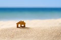 Small wooden house on a sandy beach against the background of the sea Royalty Free Stock Photo