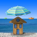 Small wooden house at seaside with umbrella beach - concept image Royalty Free Stock Photo