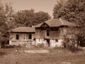 Small wooden house surrounded by trees. Mountain shabby hut image of outdoor. Sepia colour.