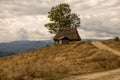 Small wooden house with thatched roof in the mountains Royalty Free Stock Photo