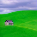 Small wooden house on top of the green hill Royalty Free Stock Photo