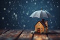 Small wooden house under umbrella in the rain, blue background, copy space. Home insurance and protection. AI generated Royalty Free Stock Photo