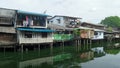 Small wooden houses on canal bank in the city Royalty Free Stock Photo