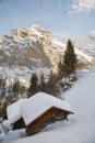 Small wooden hut covered by snow in front of majestic Jungfrau peak in Bernese Alps Royalty Free Stock Photo