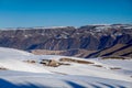 Small wooden hut at the foot of the snow-covered Tianshan Mountains in winter morning Royalty Free Stock Photo