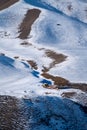 Small wooden hut at the foot of the snow-covered Tianshan Mountains in winter Royalty Free Stock Photo