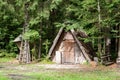 A small wooden hut in the woods serving as a storehouse for animals and feeders. Royalty Free Stock Photo