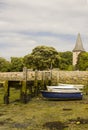 A small wooden jetty covered with barnacles and seaweed in the harbour at Bosham village in West sussex in the South of England Royalty Free Stock Photo