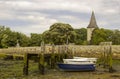 A small wooden jetty covered with barnacles and seaweed in the harbour at Bosham village in West sussex in the South of England Royalty Free Stock Photo