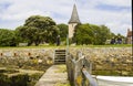 A small wooden jetty covered with barnacles and seaweed Royalty Free Stock Photo