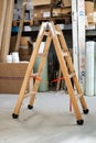 Small wooden ladders stand in the warehouse