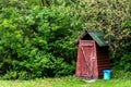 Small wooden outdoors toilet in summer Royalty Free Stock Photo