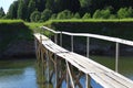 Small wooden pedestrian bridge across the river Royalty Free Stock Photo