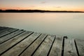 Small wooden pier on big lake at sunset Royalty Free Stock Photo