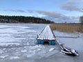 Small wooden pier on lake Seliger in January in cloudy weather of the coast of the island of Klichen. Russia, Tver region Royalty Free Stock Photo