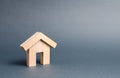 Small wooden residential house on a gray background. Mortgage and credit for the purchase. Minimalism. Isolate Real estate concept Royalty Free Stock Photo