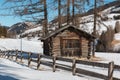 Small Wooden Shack and Fence Among Trees in Winter day with Fresh Snow in the Mountains Royalty Free Stock Photo