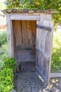 small wooden shack with toilet hole to defecate and urinate sitting down.