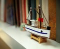 Small wooden ship on a bookshelf, travel - nostalgia concept