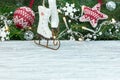 Small wooden skates against blurred fir tree branch background w