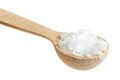 Small wooden spoon of coarse salt on white. Royalty Free Stock Photo