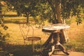 Small wooden table with a chair in a countryside garden in Normandy, France Royalty Free Stock Photo