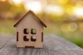 A small wooden toy house, stand on a wooden table of autumn nature Royalty Free Stock Photo