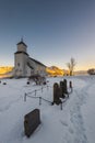 The small wooden white church in GimsÃÂ¸y on the beach on the Lofoten islands in Norway in winter with beautiful old cemetary and Royalty Free Stock Photo