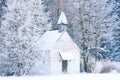 Small woody chapel in frozen snowy forest Royalty Free Stock Photo