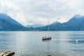 Small yacht docked in the marina of Varenna, one of the most picturesque towns on the shore of Lake Como. Varenna, Italy Royalty Free Stock Photo