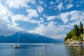 Small yacht docked in the marina of Varenna, one of the most picturesque towns on the shore of Lake Como. Varenna, Italy Royalty Free Stock Photo