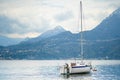 Small yacht docked in the marina of Varenna, one of the most picturesque towns on the shore of Lake Como. Varenna, Italy Royalty Free Stock Photo