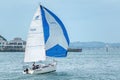 small yacht jumping wake with full spinnaker Royalty Free Stock Photo