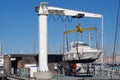 Small yacht lifted out of water for maintenance and light repairs before the season starts.