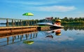 A small yacht is moored to the pier and ready to relax on the river. Beach green Royalty Free Stock Photo