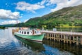 Small yacht at a pier on a lake at the Lake District in England