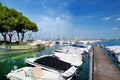 Small yachts in harbor in Desenzano del Garda on beautiful autumn day Royalty Free Stock Photo