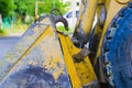Small yellow bulldozer loader bucket. scratched old metal Royalty Free Stock Photo