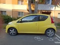 A small yellow car in a city
