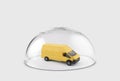 Yellow cargo delivery truck protected under a glass dome